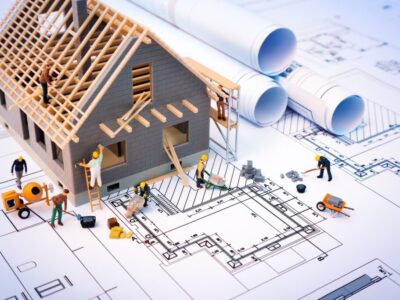 building house on blueprints with worker - construction project building house on blueprints with worker - construction project
